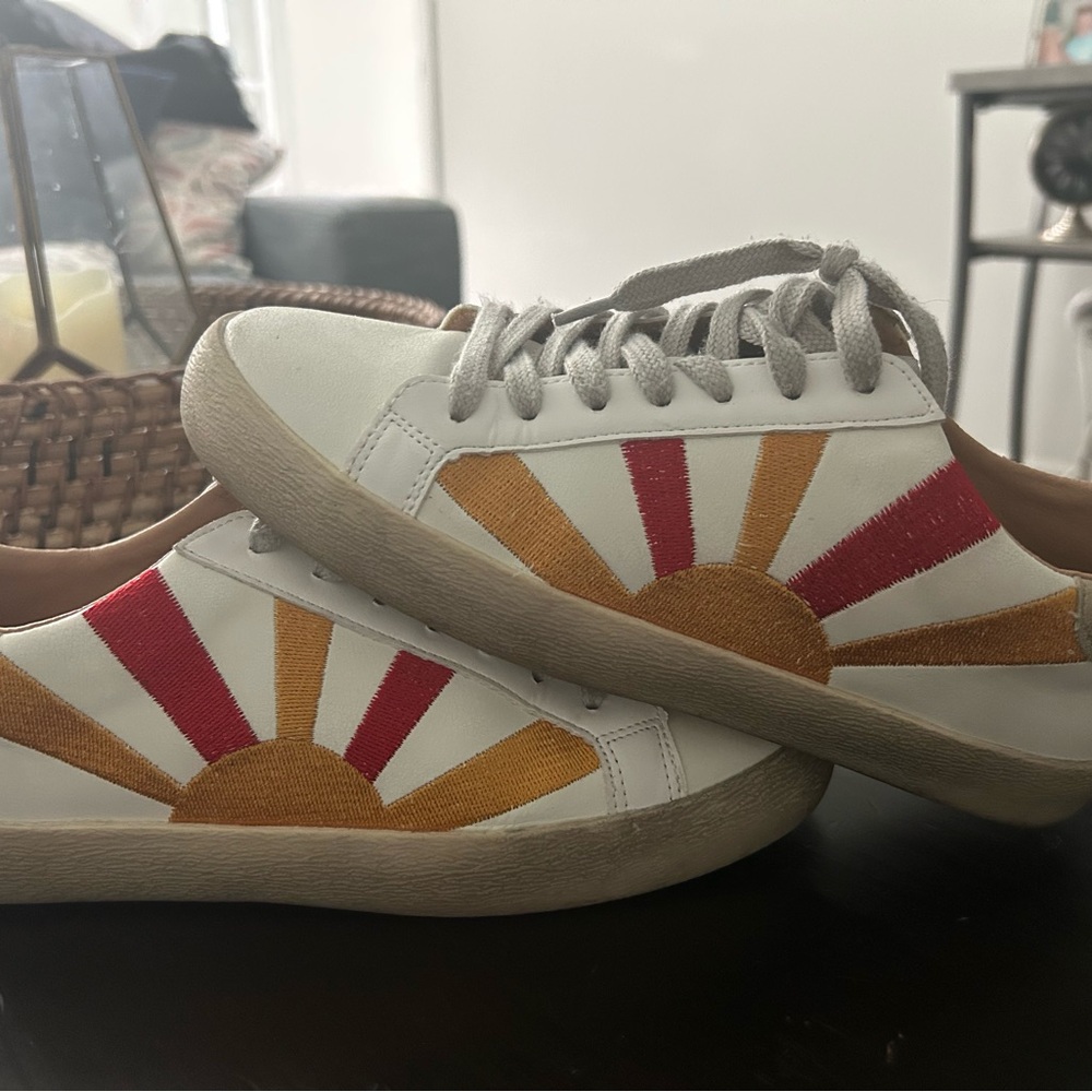 White Sneakers with Red and Yellow Sunburst Design
